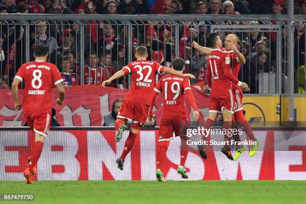 James Rodriguez of Bayern Muenchen celebrates with Arjen Robben of Bayern Muenchen after he scored his teams first goal to make it 1:0 during the...