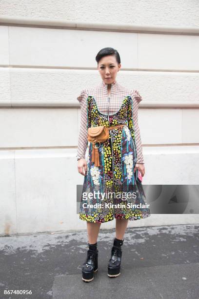 Buying Manager of women's designer wear for Selfridges Jeannie Lee wears a Mary Katrantzou dress, Chloe belt bag and Sacai shoes day 3 of Paris...