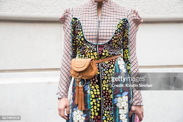 Buying Manager of women's designer wear for Selfridges Jeannie Lee wears a Mary Katrantzou dress, Chloe belt bag day 3 of Paris Womens Fashion Week...