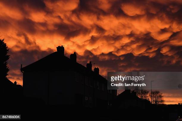 Mammatus clouds form over houses at sunset on October 28, 2017 in Saltburn-by-the-Sea, England. Mammatus means mammary cloud and they are a cellular...