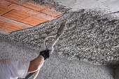 Construction worker applying cement plaster