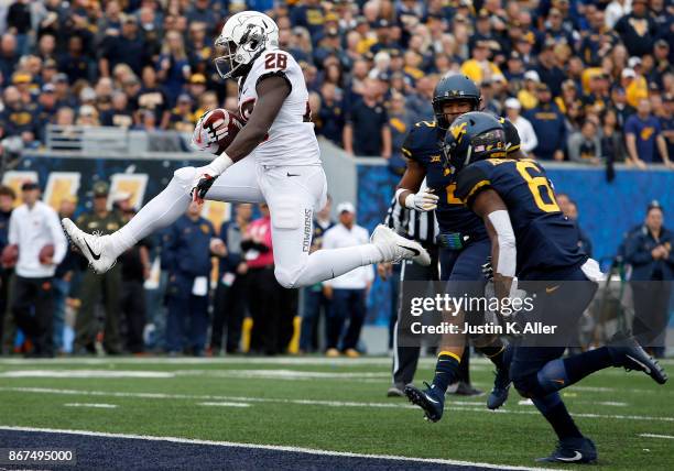 James Washington of the Oklahoma State Cowboys scores on a 13 yard touchdown pass in the first half against the West Virginia Mountaineers at...