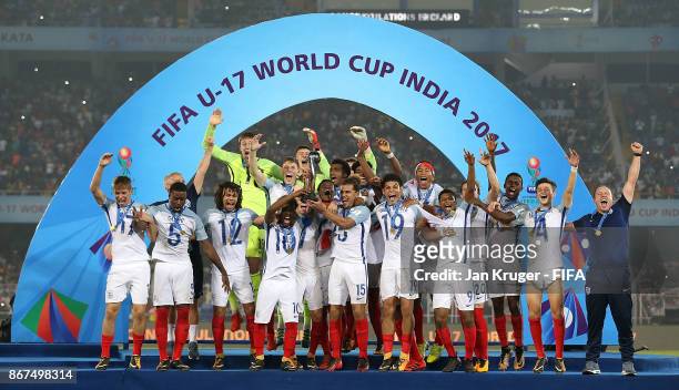 Angel Gomez and Joel Latibeaudiere of England lift the winners trophy during the FIFA U-17 World Cup India 2017 Final match between England and Spain...