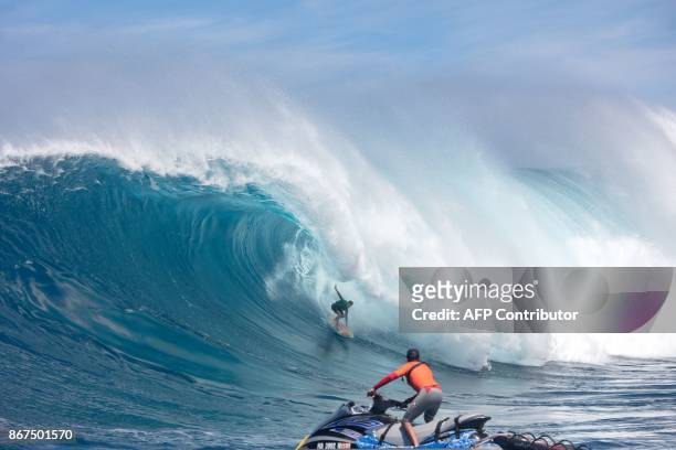 Mark Healy from Hawaii rides a big wave at Jaws , off the coast of the Maui Island in Hawaii on the first day of the Pe'ahi Challenge 2017, on...