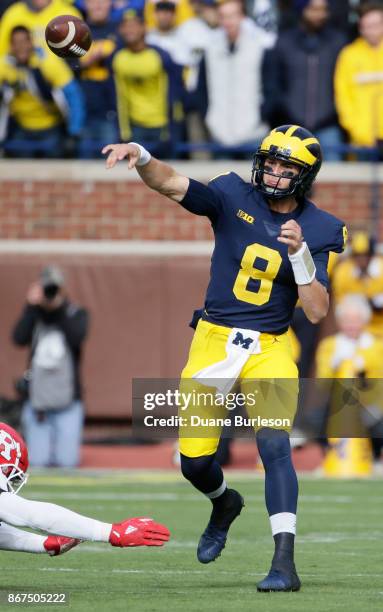 Quarterback John O'Korn of the Michigan Wolverines passes the ball against the Rutgers Scarlet Knights during the first half at Michigan Stadium on...