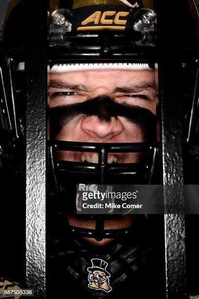 Tight end Jack Freudenthal of the Wake Forest Demon Deacons waits behind the entrance gate to the field before the Deacons' football game against the...
