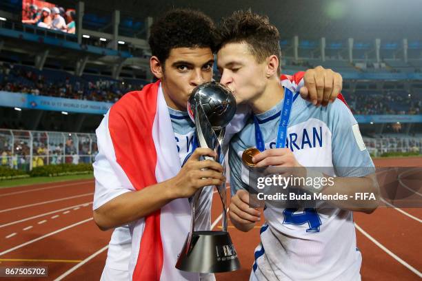 Morgan Gibbs White and George McEachran kisses the trophy after winning the FIFA U-17 World Cup India 2017 Final match between England and Spain at...