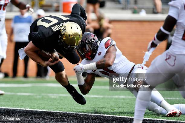 Quarterback John Wolford of the Wake Forest Demon Deacons rushes for a touchdown against the Louisville Cardinals in the first quarter at BB&T Field...