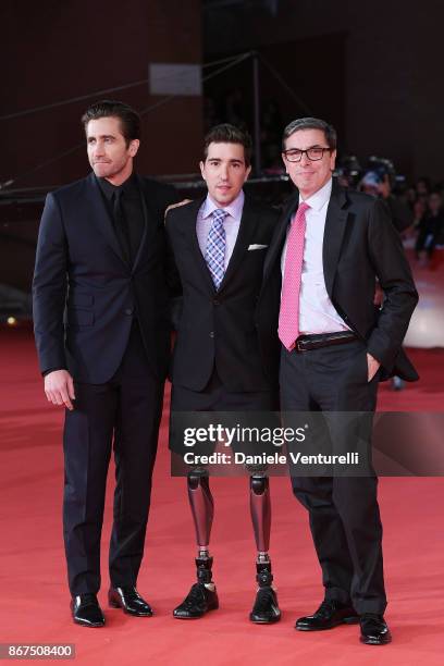 Jake Gyllenhaal, Jeff Bauman and Antonio Monda walk a red carpet for 'Stronger' during the 12th Rome Film Fest at Auditorium Parco Della Musica on...