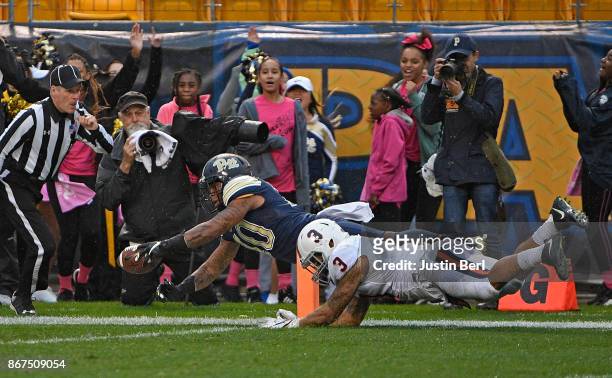 Quadree Henderson of the Pittsburgh Panthers dives into the end zone for a 75 yard punt return touchdown in the second quarter during the game...