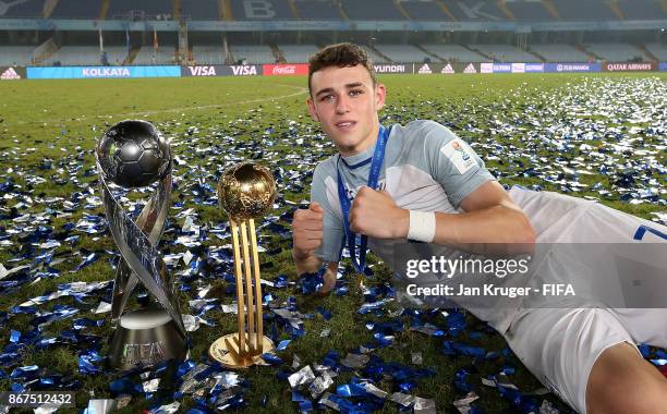 Philip Foden of England poses with the winners trophy and best young player trophy during the FIFA U-17 World Cup India 2017 Final match between...