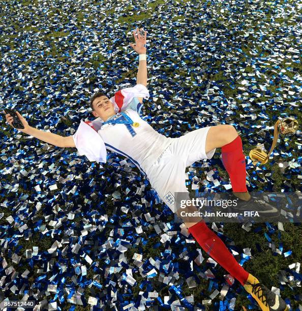 Philip Foden of England poses with the winners trophy and best young player trophy during the FIFA U-17 World Cup India 2017 Final match between...