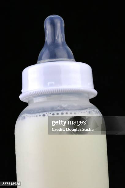 close-up of a plastic baby bottle with mothers milk - electrolyte stock pictures, royalty-free photos & images