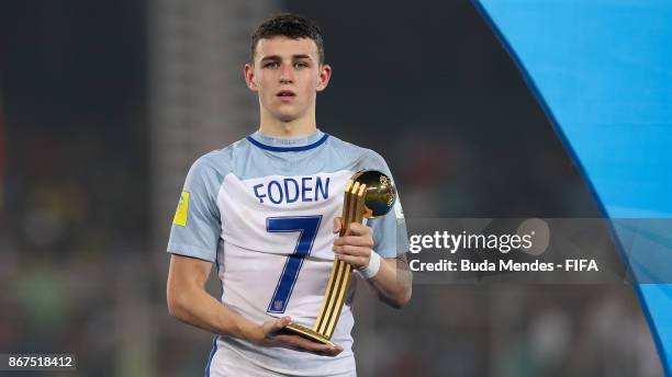 Philip Foden of England poses with the best young player trophy of the FIFA U-17 World Cup India 2017 Final match between England and Spain at...