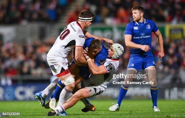 Belfast , United Kingdom - 28 October 2017; Jordan Larmour of Leinster is tackled by Robbie Diack, left, and Luke Marshall of Ulster during the...