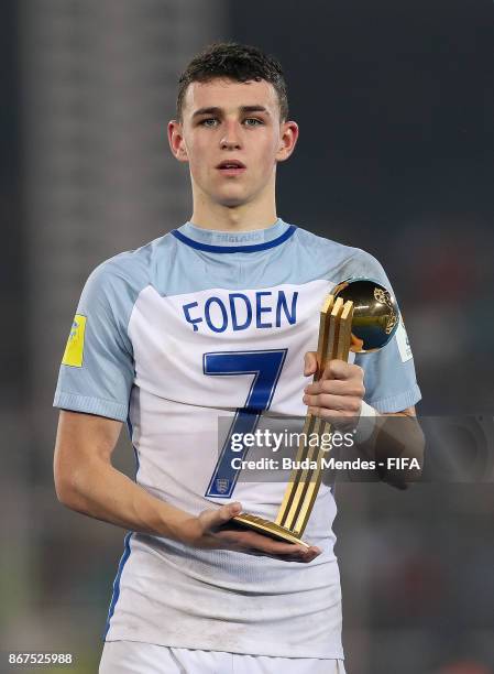 Philip Foden of England poses with the best young player trophy of the FIFA U-17 World Cup India 2017 Final match between England and Spain at...