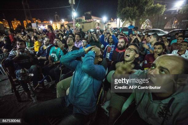 Egyptian fanse gather at a sports cafe to watch the CAF Champions League final football match between Al-Ahly vs Wydad Casablanca, in Cairo's 6th of...