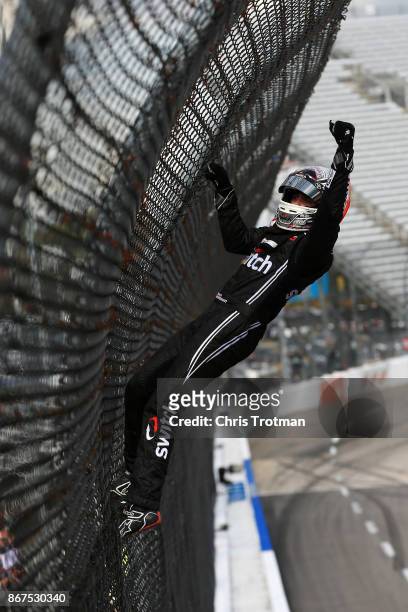 Noah Gragson, driver of the Switch Toyota, celebrates by climbing the frontstretch fence after winning the NASCAR Camping World Truck Series Texas...