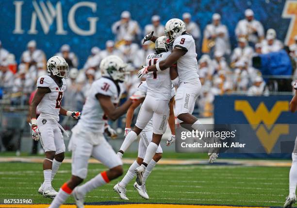 Green of the Oklahoma State Cowboys celebrates after one of his four interceptions against the West Virginia Mountaineers at Mountaineer Field on...