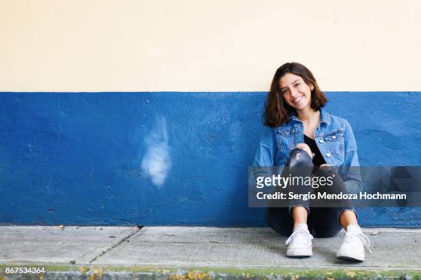one hispanic teenage girl sitting on the floor in mexico city, mexico - beautiful mexican girls stock pictures, royalty-free photos & images