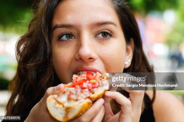 one hispanic teenage girl eating mexican food in mexico city, mexico - female eating chili bildbanksfoton och bilder
