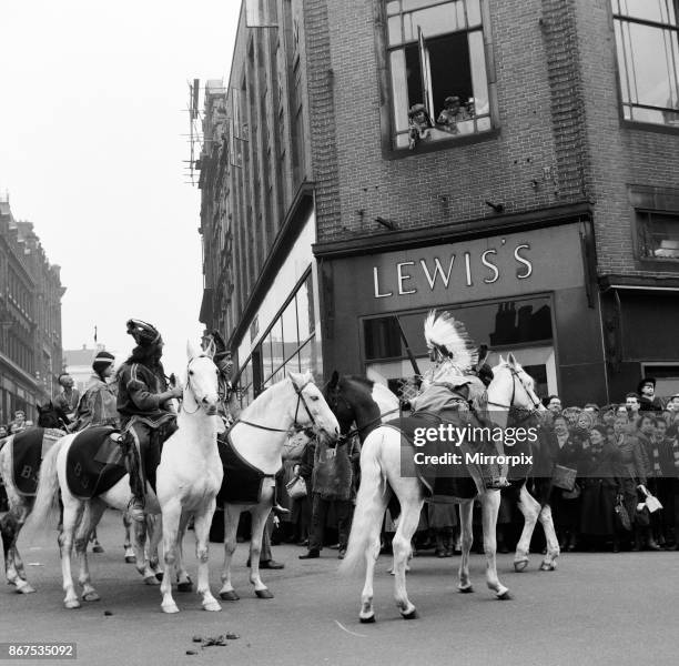 Cowboys and Indians from Billy Smarts Circus ride into town and stage a running fight outside the local store, Lewis's. Davy Crocket Smart fights off...