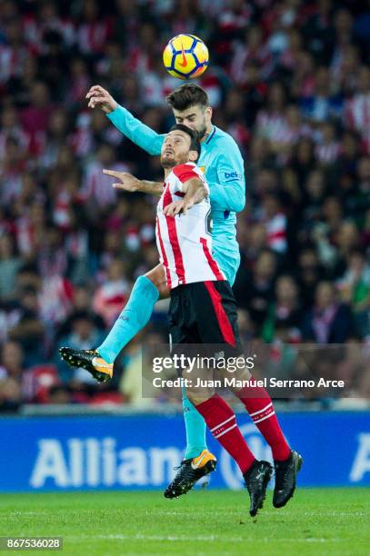 Gerard Pique of FC Barcelona competes for the ball with Aritz Aduriz of Athletic Club during the La Liga match between Athletic Club Bilbao and FC...