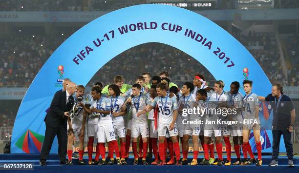 President Gianni Infantino delivers the champion trophy to the captain Angel Gomes of England after the FIFA U-17 World Cup India 2017 Final match...