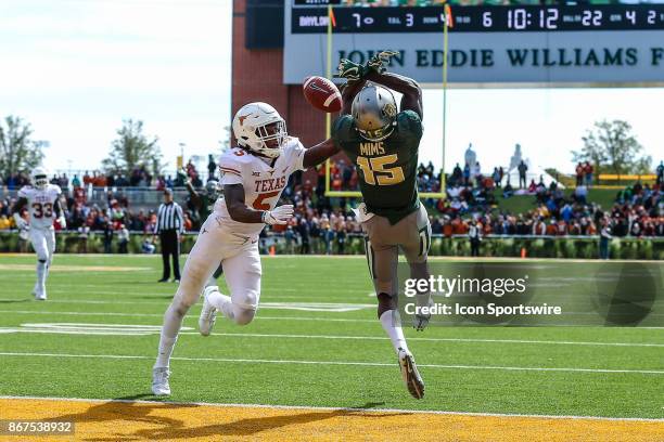 Baylor Bears wide receiver Denzel Mims and Texas Longhorns defensive back Holton Hill battle for the football as it falls incomplete during the game...