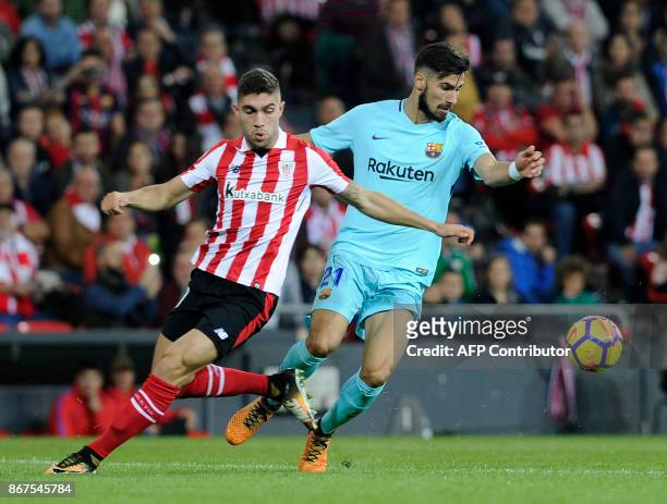 Athletic Bilbao's Spanish defender Unai Nunez vies with Barcelona's Portuguese midfielder Andre Gomes during the Spanish league football match...
