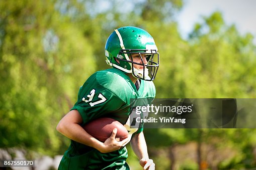 High School or University American Football Player Playing in Field High School or University American Football Player Playing in Field
