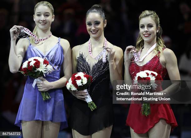 Silver medalist Maria Sotskova of Russia, gold medalist Kaetlyn Osmond of Canada and bronze medalist Ashley Wagner of USA in the victory ceremony for...