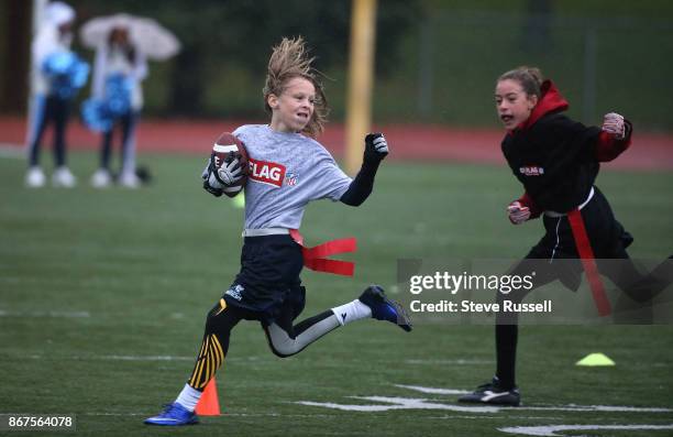 Henry Podivinsky out runs a defender to score a touchdown. The CFL-NFL are hosting a flag football regional tournament featuring co-ed teams of 10-11...