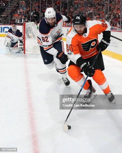 Matt Read of the Philadelphia Flyers skates the puck against Eric Gryba of the Edmonton Oilers on October 21, 2017 at the Wells Fargo Center in...