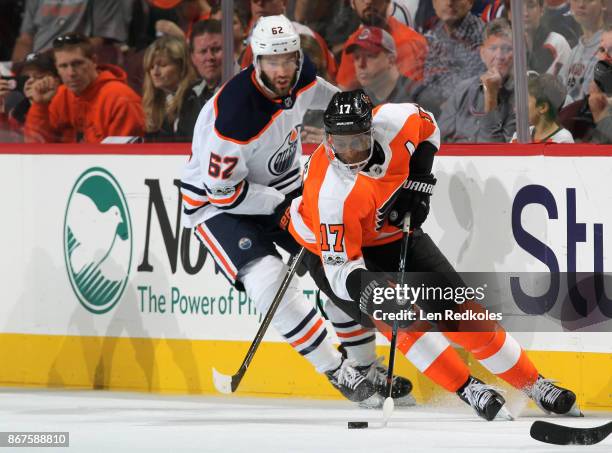 Wayne Simmonds of the Philadelphia Flyers skates the puck against Eric Gryba of the Edmonton Oilers on October 21, 2017 at the Wells Fargo Center in...