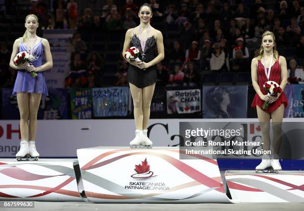 Silver medalist Maria Sotskova of Russia, gold medalist Kaetlyn Osmond of Canada and bronze medalist Ashley Wagner of USA in the victory ceremony for...