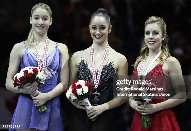 Silver medalist Maria Sotskova of Russia, gold medalist Kaetlyn Osmond of Canada and bronze medalist Ashley Wagner of USA in the victory ceremony for...