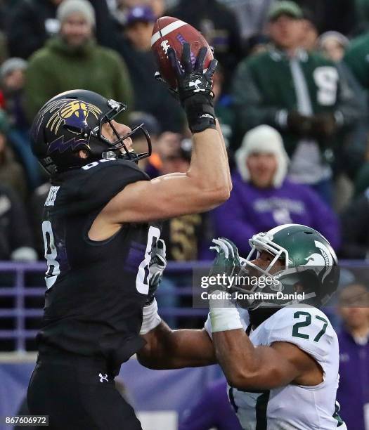 Bennett Skowronek of the Northwestern Wildcats catches a touchdown pass over Khari Willis of the Michigan State Spartans at Ryan Field on October 28,...