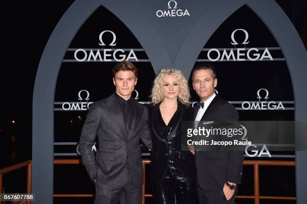 Oliver Cheshire, Pixie Lott and Raynald Aeschlimann attend the OMEGA Aqua Terra at Palazzo Pisani Moretta on October 28, 2017 in Venice, Italy.