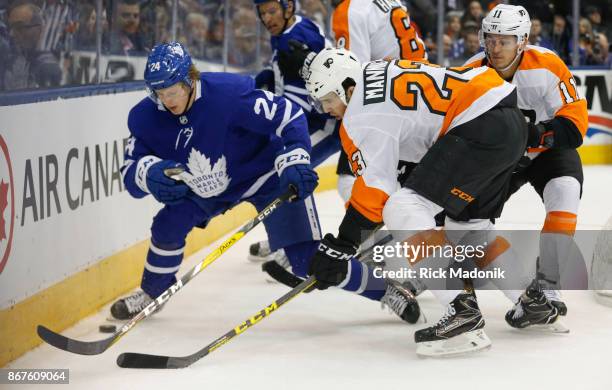 Toronto Maple Leafs right wing Kasperi Kapanen works the puck along the boards with Philadelphia Flyers defenseman Brandon Manning . Oronto Maple...