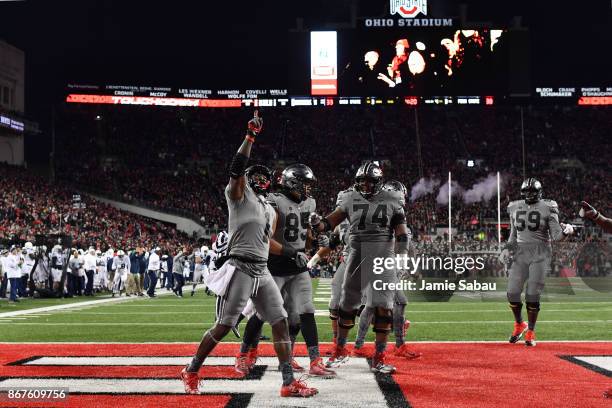 Johnnie Dixon of the Ohio State Buckeyes celebrates after catching a 10-yard touchdown pass in the fourth quarter against the Penn State Nittany...