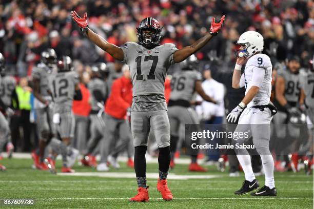 Jerome Baker of the Ohio State Buckeyes celebrates after stopping Penn State on downs in the fourth quarter as quarterback Trace McSorley of the Penn...