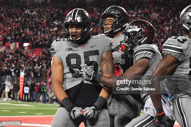 Marcus Baugh of the Ohio State Buckeyes celebrates with teammates after catching a 16-yard touchdown pass in the fourth quarter against the Penn...