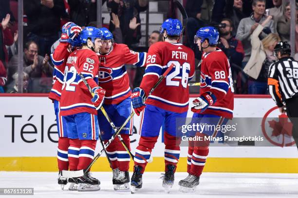 Members of the Montreal Canadiens celebrate a goal in the first period by Paul Byron against the New York Rangers during the NHL game at the Bell...