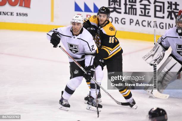 Alec Martinez of the Los Angeles Kings watches the play against Kenny Agostino of the Boston Bruins at the TD Garden on October 28, 2017 in Boston,...