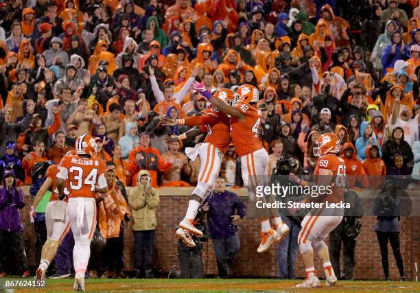 Teammates Milan Richard and Christian Wilkins of the Clemson Tigers celebrate after a touchdown against the Georgia Tech Yellow Jackets during their...
