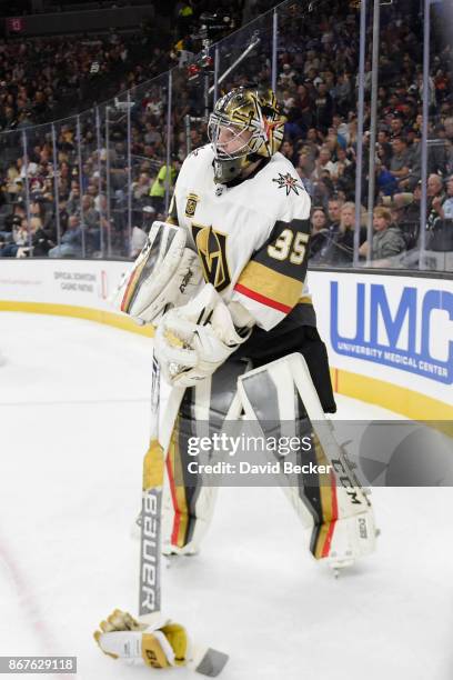 Oscar Dansk of the Vegas Golden Knights picks up a glove during a break in the game against the Colorado Avalanche during the game at T-Mobile Arena...