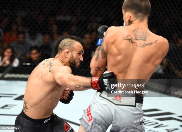 John Lineker of Brazil punches the body of Marlon Vera of Ecuador in their bantamweight bout during the UFC Fight Night event inside the Ibirapuera...