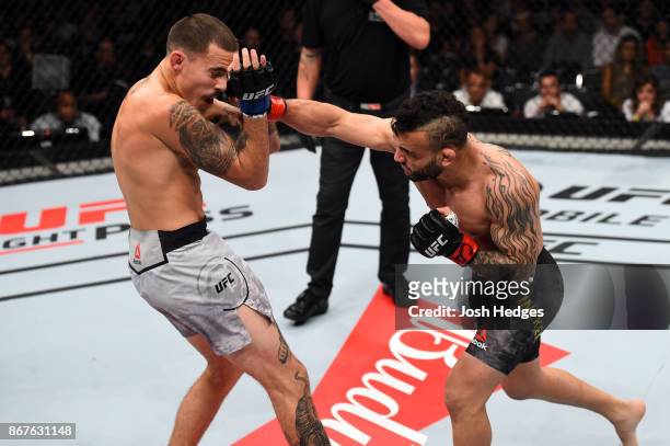 John Lineker of Brazil punches Marlon Vera of Ecuador in their bantamweight bout during the UFC Fight Night event inside the Ibirapuera Gymnasium on...