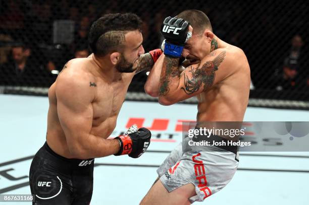 John Lineker of Brazil punches Marlon Vera of Ecuador in their bantamweight bout during the UFC Fight Night event inside the Ibirapuera Gymnasium on...